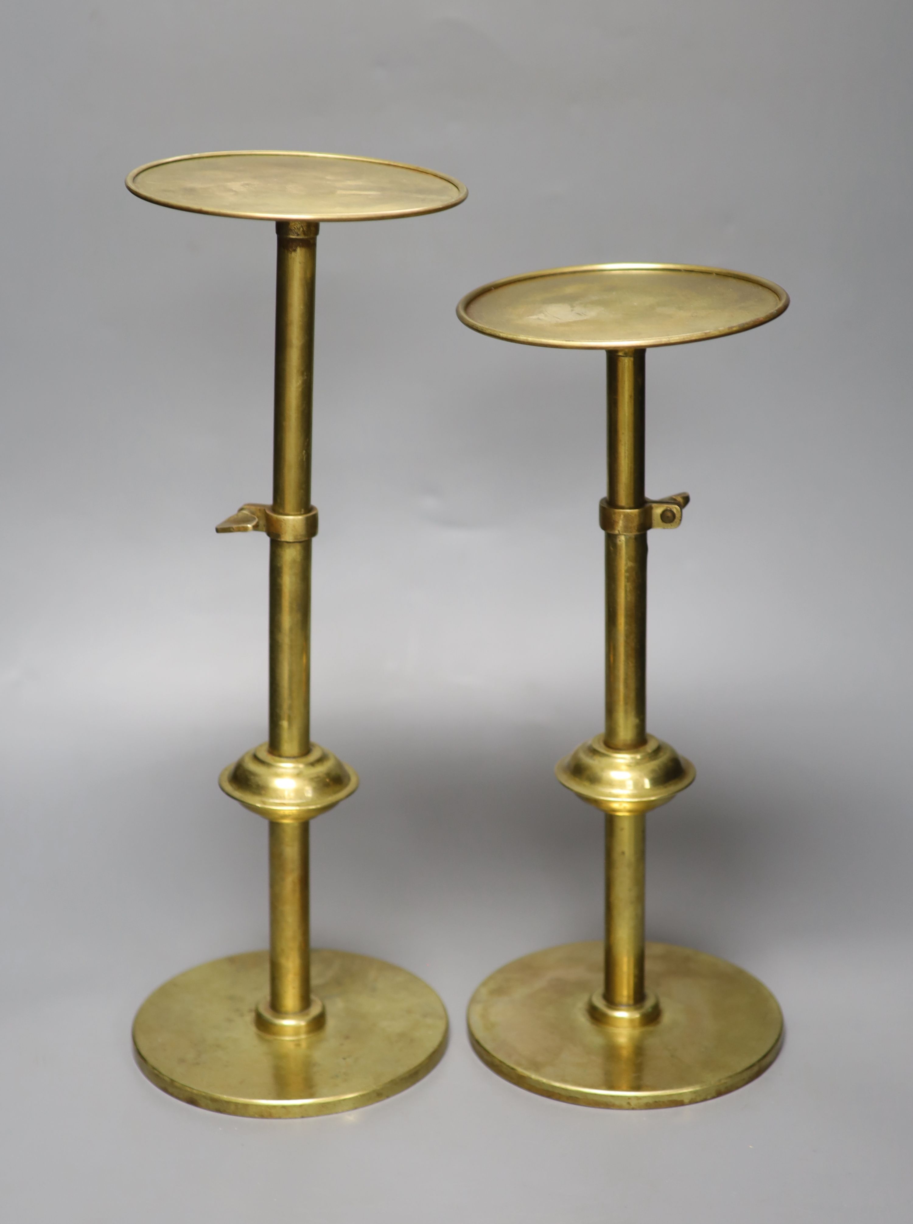 A pair of brass telescopic display stands